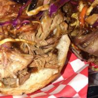 Smoky Pulled Pork Sandwich · Vinaigrette slaw, house pickled onions, smoky sweet BBQ sauce #5. served with 2 sides.