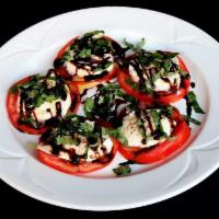 Caprese Salad · Fresh mozzarella, tomatoes and fresh basil with extra virgin olive oil and balsamic reduction.