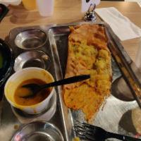 Ghee Rava Masala Dosa · Rice and semolina crepe filled with potatoes and peas masala topped with ghee served with sa...