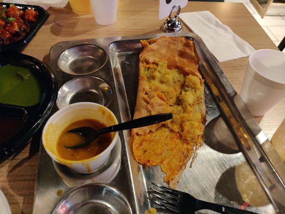 Ghee Rava Masala Dosa · Rice and semolina crepe filled with potatoes and peas masala topped with ghee served with sambar, coconut and tomato chutney.