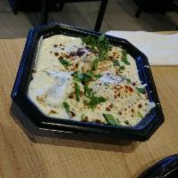 Dahi Vada · Dipped fried lentils cake dipped in yogurt topped with cilantro, chilli and cumin powder and...