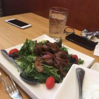 Luc Lac Beef · Cubed filet mignon marinated in rice wine, tossed in butter and red onions with mixed greens...