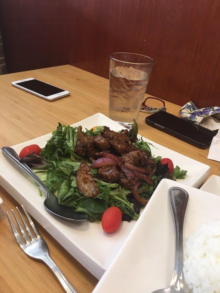 Luc Lac Beef · Cubed filet mignon marinated in rice wine, tossed in butter and red onions with mixed greens, served with jasmine rice. Raw.