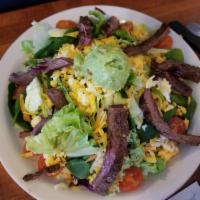 Fajita Salad · Beef or chicken on a bed of lettuce, tomatoes, cucumbers, bell peppers, onions, grated chees...