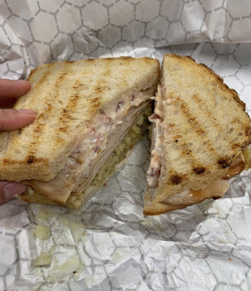 Thanksgiving Sandwich · Thanksgiving put between 2 slices of sourdough bread. Sliced turkey breast, stuffing, and gravy. Finished with house-made cranberry aioli.