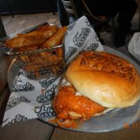 Buffalo Chicken Sandwich · Crispy chicken breast tossed in Buffalo sauce, topped with bleu cheese dressing, with choppe...