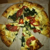 White Pizza · No red sauce. Prepared with sliced tomatoes, garlic, spinach, ricotta cheese and mozzarella ...