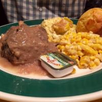 Pot Roast · Tender pot roast topped with brown gravy made from the drippings, blue plate served with 2 s...