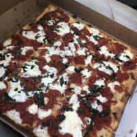 Old World Brooklyn Pie · Square thin crispy pizza with Piccolo's secret plum tomato sauce, fresh mozzarella, fresh ba...
