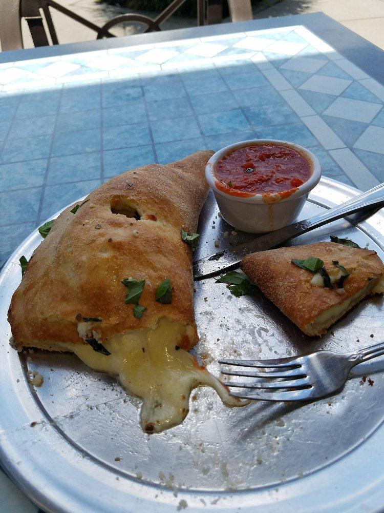 Calzone · Piccolo's special ricotta and mozzarella cheese mix in a dough pocket baked to perfection. Topped with fresh basil, parmigiano cheese, extra virgin olive oil and side of marinara sauce.