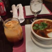 Tom Yum Soup · Savory sour soup with shrimp, mushrooms, lemongrass, lime leaves, tomatoes, chilies and cila...