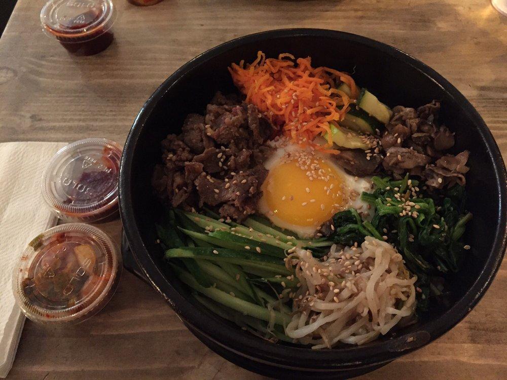 Bulgogi Bibim Rice · Marinated, thinly sliced rib eye steak, carrot, cucumber, mushroom, zucchini, bean sprout, spinach and sunny side up egg, drizzled with sesame seed and oil. Served on sticky rice with homemade chili sauce.
