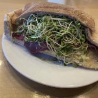 Natural High Sandwich · A warm sandwich with a wheat pita stuffed with Monterey Jack and cheddar cheese, avocado, mu...