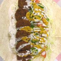 Colossal Falafel Wrap · Golden falafels, lettuce, tomatoes, onions, cabbage, hummus, and tahini sauce.