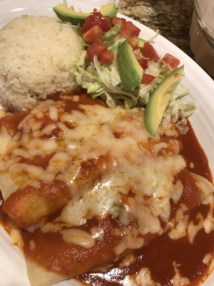 Enchiladas Chipotle · 3 chicken enchiladas topped with chipotle sauce and cheese served with white rice, lettuce, guacamole and tomatoes.