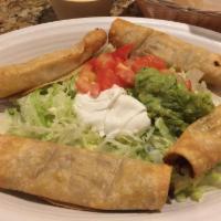 Taquitos Mexicanos · Corn fried taquitos (2 chicken and 2 beef tips) served with lettuce, guacamole, tomatoes and...