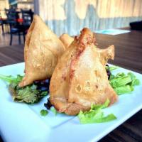Vegetable Samosa · Crispy pastries stuffed with potatoes and peas lightly seasoned with spices. Vegetarian.