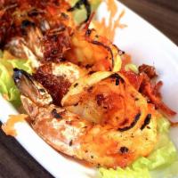 Malaysian Shrimp · Grilled Malaysian-spiced shrimp served over a carrot slaw with shrimp sauce. Spicy.