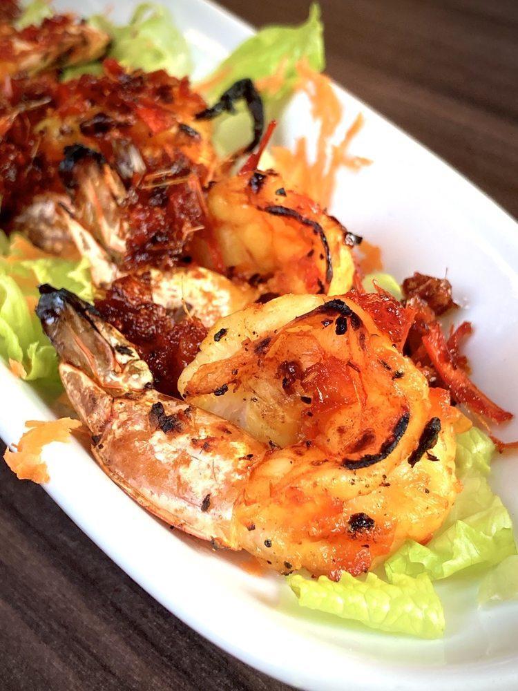 Malaysian Shrimp · Grilled Malaysian-spiced shrimp served over a carrot slaw with shrimp sauce. Spicy.