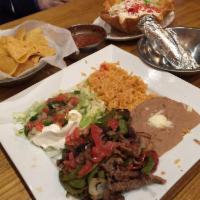 Steak Fajita · Served with sizzling on a bed of bell peppers tomatoes and onions with Mexican rice and bean...