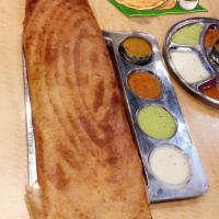 Paper Masala Dosa · Thin lengthy rice and lentil crepe filled with mildly spiced mashed potatoes and onions.