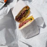 Hot Pastrami Sandwich · Pastrami brisket marinated overnight steamed in our kettle, cheddar cheese and Lou's special...