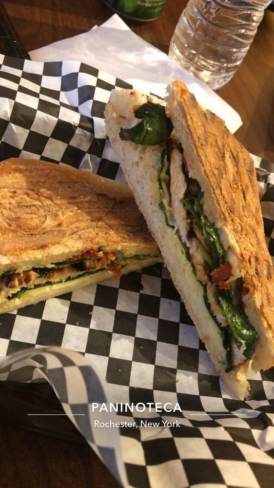 Grilled Chicken Panini · Grilled chicken breast, marinated in lemon and garlic with sun-dried tomatoes, Asiago cheese, spinach and lemon aioli. Served with chips.