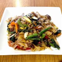 Drunken Noodles · Wide rice noodles with egg, bell peppers, onions, green beans, carrots, zucchini, and basil.
