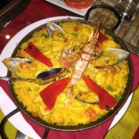 Paella Valenciana · Traditional Spanish seafood paella with shrimps, fish, squids, scallops and prawns.