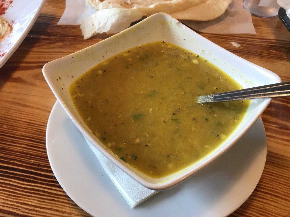 Lentil Soup · A tasty soup made of red lentils and shredded carrot, seasoned with onions and garlic. Hearty and filling, garnished with a slice of lemon. Vegan. Gluten free.