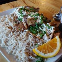 Gyro Plate · Thin slices of seasoned lamb and beef, served over a bed of basmati rice with spicy garlic s...