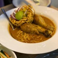 Kao Soi Gai · Egg noodle, yellow curry, chicken drumstick, pickle cabbage, crispy egg noodle, red onion, s...