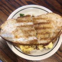 Anaheim Panini · Scrambled eggs, bacon, tomato, green onion, avocado, cheddar, grilled sourdough.