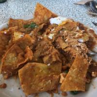 Chilaquiles · corn tortilla chips, chicken, 2 eggs, cheddar, ranchero sauce, pico de gallo, sour cream, gr...