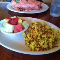 Tofu Scramble Special · Made with firm tofu and savory herbs sautéed with onions and garlic. Served with home fries ...