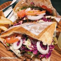 Grand Berlin Doner · Your choice of meat, lettuce, red cabbage, tomato, onions, 3 signature sauces in a crispy do...