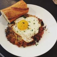 Breakfast Turkey Confit Hash Sandwich with Fried Egg · Chopped meat, potatoes, and onions. Poultry sandwich.