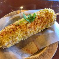 Elote · Corn on the cob smothered with butter, mayo, sprinkled with cheese and chili powder.