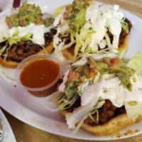 Sope · The smaller one shown. Comes with lettuce, cheese, beans, or guacamole sour cream.
