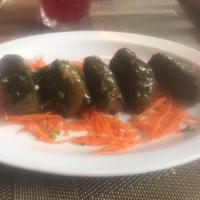 Dolma · Stuffed grape leaves with rice, herbs, olive oil and lemon juice.