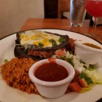 Blue Corn Enchiladas · Choice of slow-cooked shredded beef, chicken, or calabacitas. Served with rice and pinto bea...