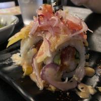 Nick's Mango Inferno Roll · Shrimp tempura, spicy tuna, cucumber and avocado topped with mango, chili flakes, onions, to...