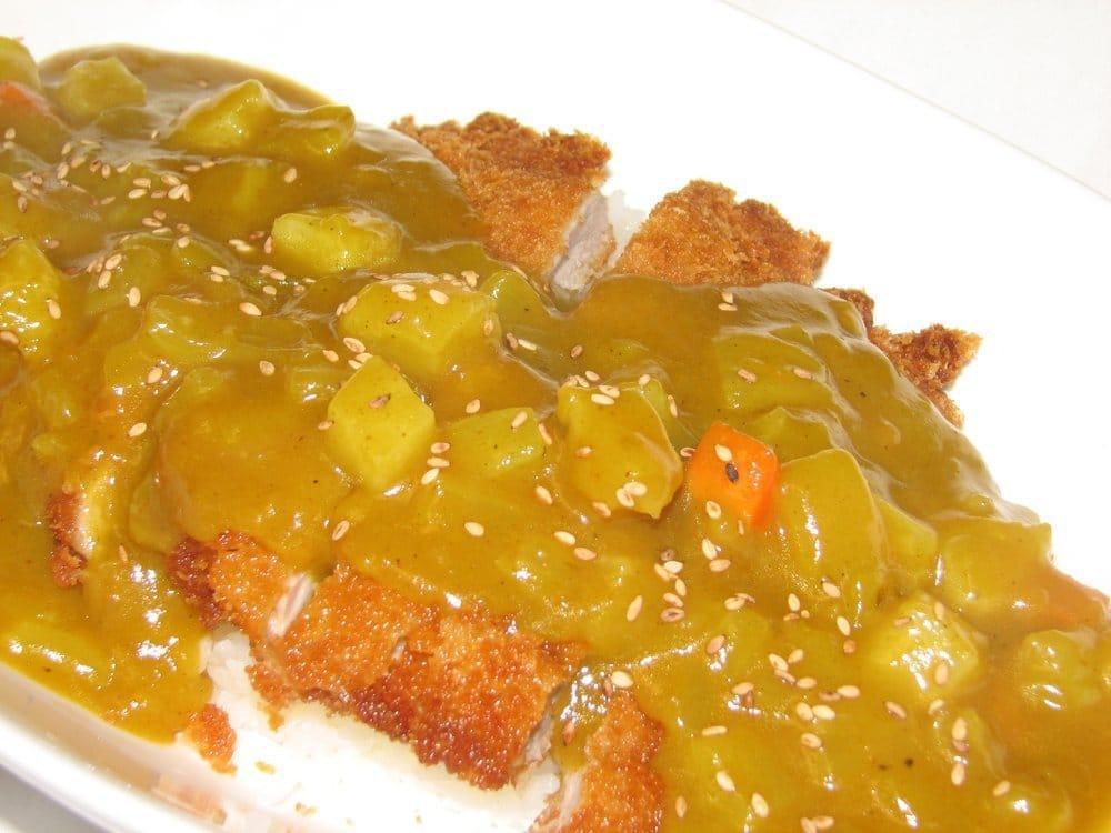 Curry Katsu · Japanese style curry over tender pork. Served with salad, and rice.