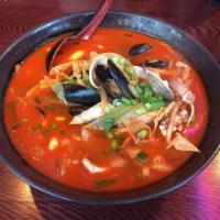 Spicy Seafood Ramen · Served with salad.