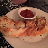 Calzone · Your choice of 2 pizza toppings, mozzarella cheese baked inside our made from scratch dough....