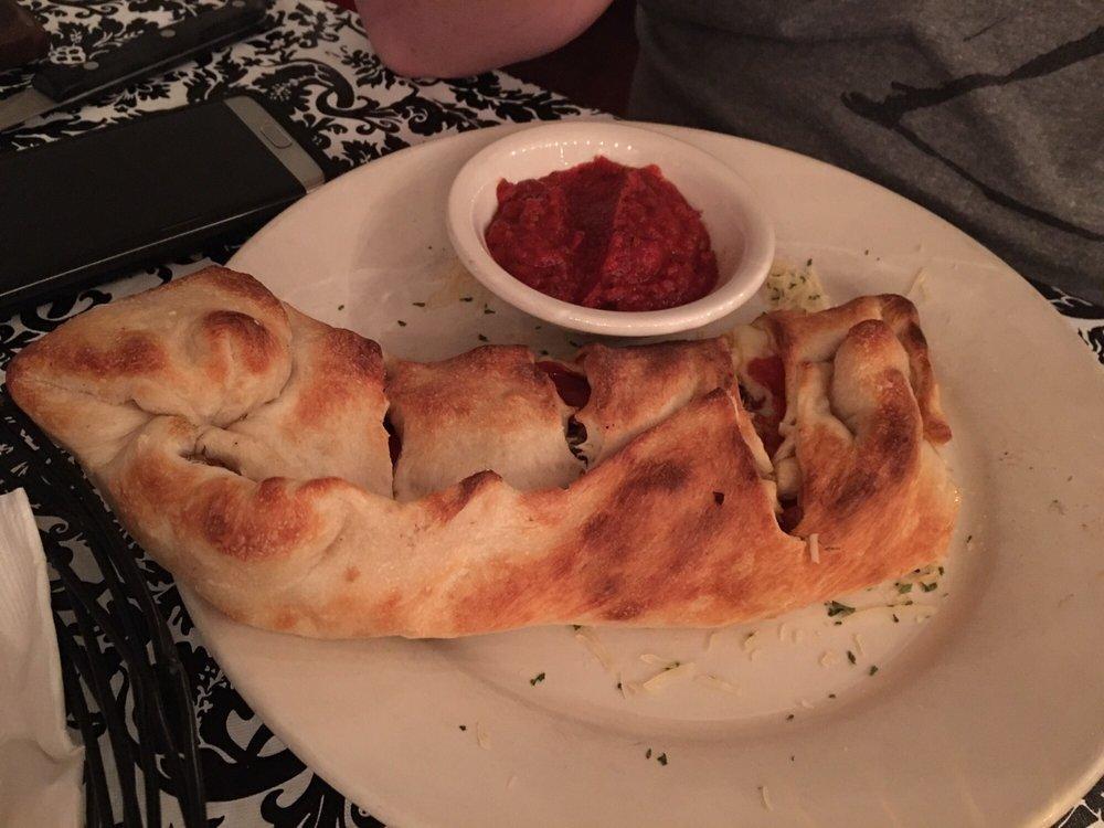 Calzone · Your choice of 2 pizza toppings, mozzarella cheese baked inside our made from scratch dough. Served with a side of marinara sauce.