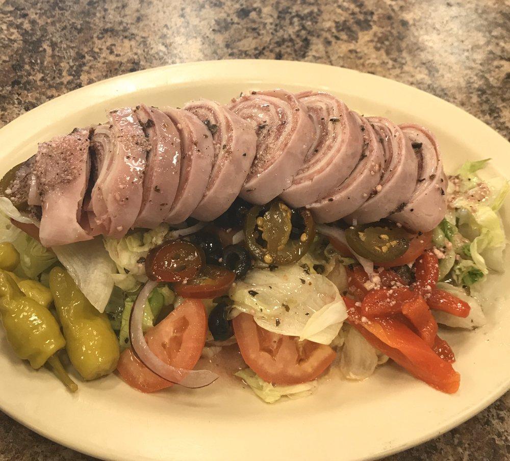 Antipasto Salad · Lettuce, tomatoes, olives, red onions, ham, salami, provolone, prosciutto, roasted peppers, marinated mushrooms, spicy pepperoncini, oil and vinegar.
