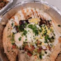 Hummus Sabich · Our homemade hummus topped with Fried eggplant, a hard-boiled egg, and drizzled with tahini.