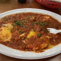 Shakshuka · Eggs poached in a spicy Mediterranean sauce. Served with pita bread.