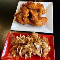 Takoyaki · Fried octopus dumplings lightly drizzled with Japanese mayonnaise, katsu sauce and sprinkled...